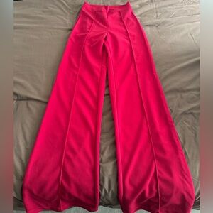 Woman vibrant red wide-leg dress pants.